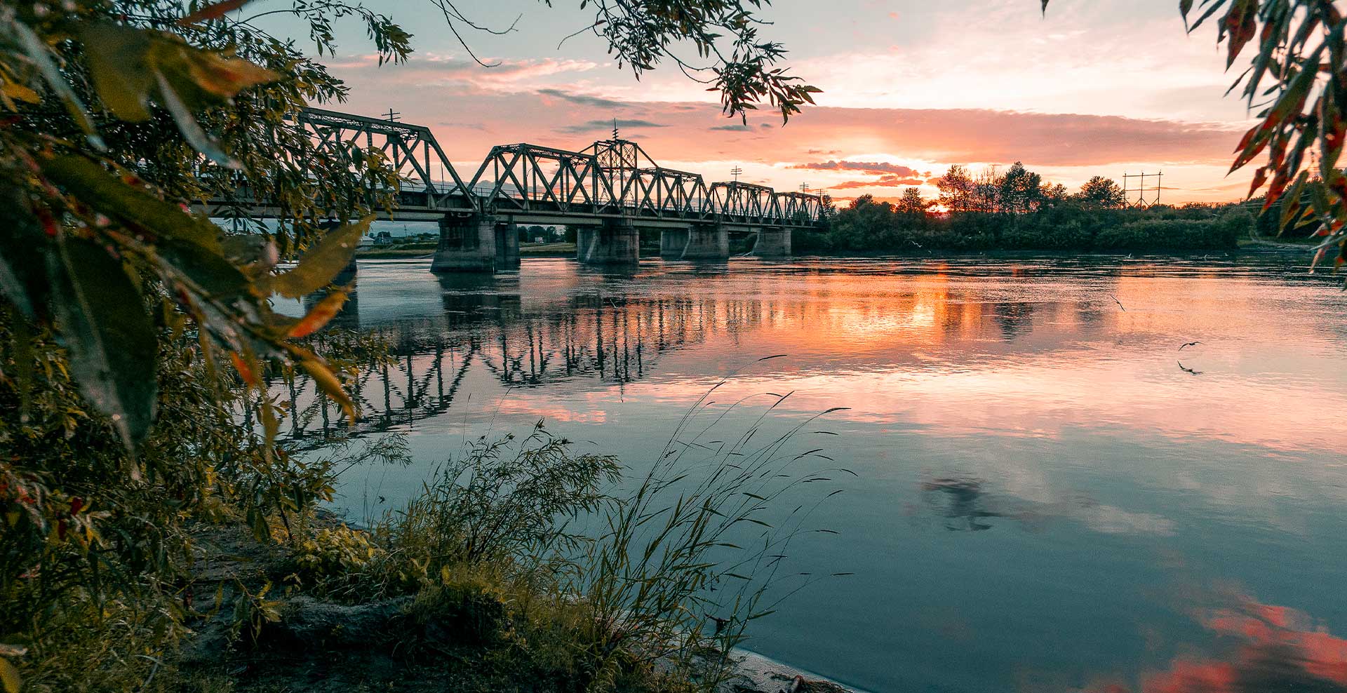 sunrise photo of the bridge crossing The Pas to OCN