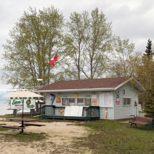 Exterior of Sam's Sack Bar with the picnic table and bench out front
