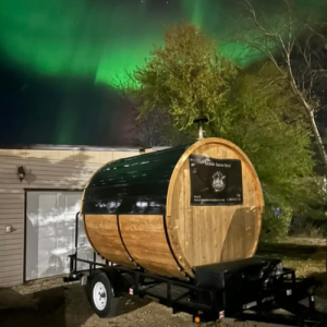 portable sauna at night with the northern lights in the background