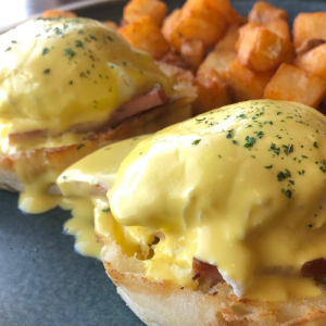 eggs benedict with hollandaise sauce and skillet potatoes