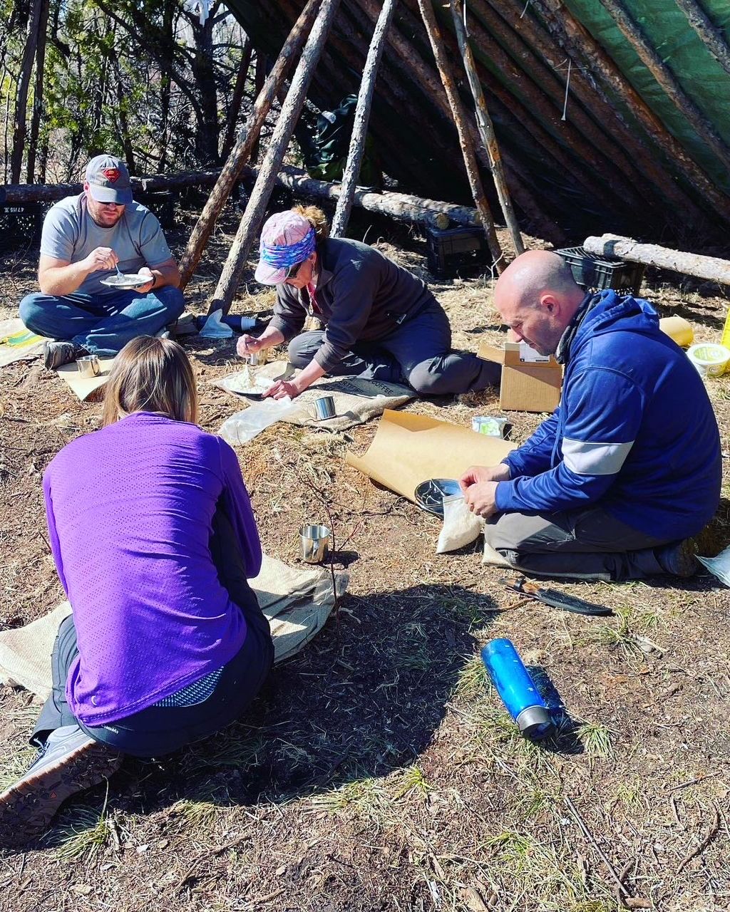 Adrianna with a crew of people learning some wilderness survival techniques