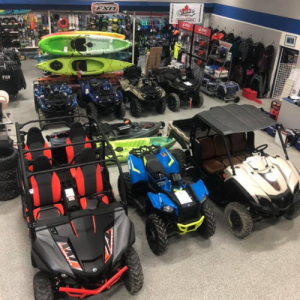 interior of sales floor showing ATVs, kayaks, clothing and more