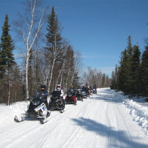 Line of snowmobiles on a trail