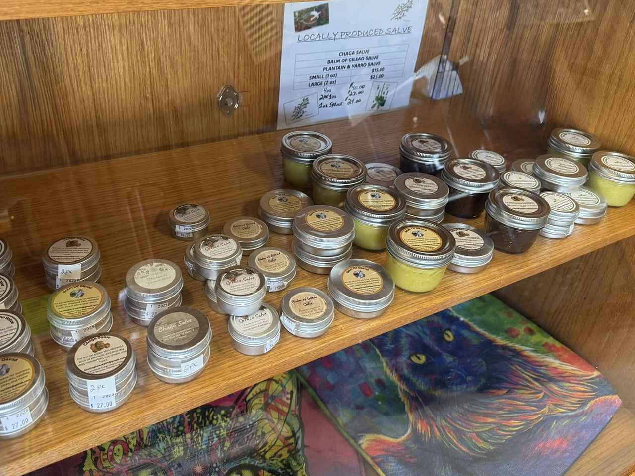 Shelf displaying locally made health products like salves