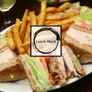 clubhouse sandwich and fries with Lunch Shack Logo on top